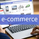 E-commerce: Person online shopping using a smartphone with "item added to cart" and laptop displaying an online store.