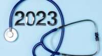 2023 health medical insurance. 2023 New Year background with stethoscope on blue