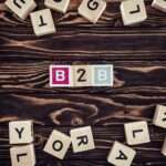 flat lay with b2b inscription made of blocks on brown wooden tabletop