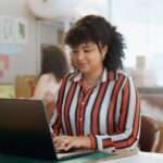 Small business, research and happy woman with laptop in office for logistics, sales or ecommerce. S